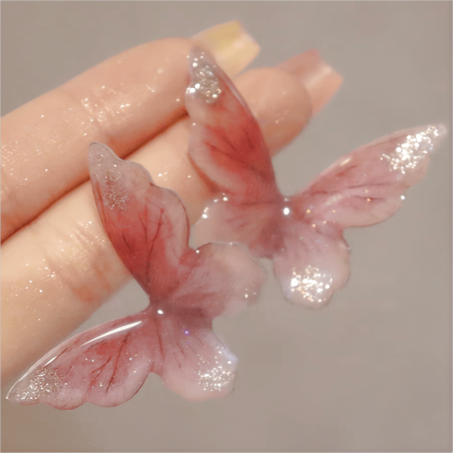 Eleganti orecchini pendenti a forma di farfalla rosa
