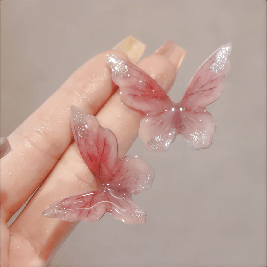 Eleganti orecchini pendenti a forma di farfalla rosa
