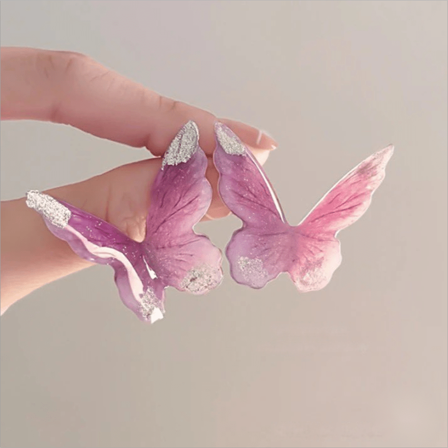Eleganti orecchini pendenti a forma di farfalla rosa